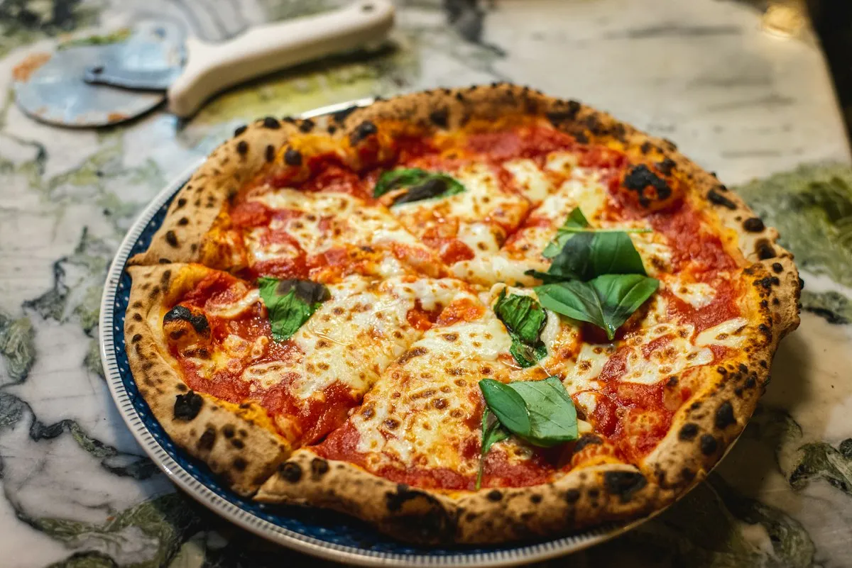 A table covered with freshly baked apizza pies